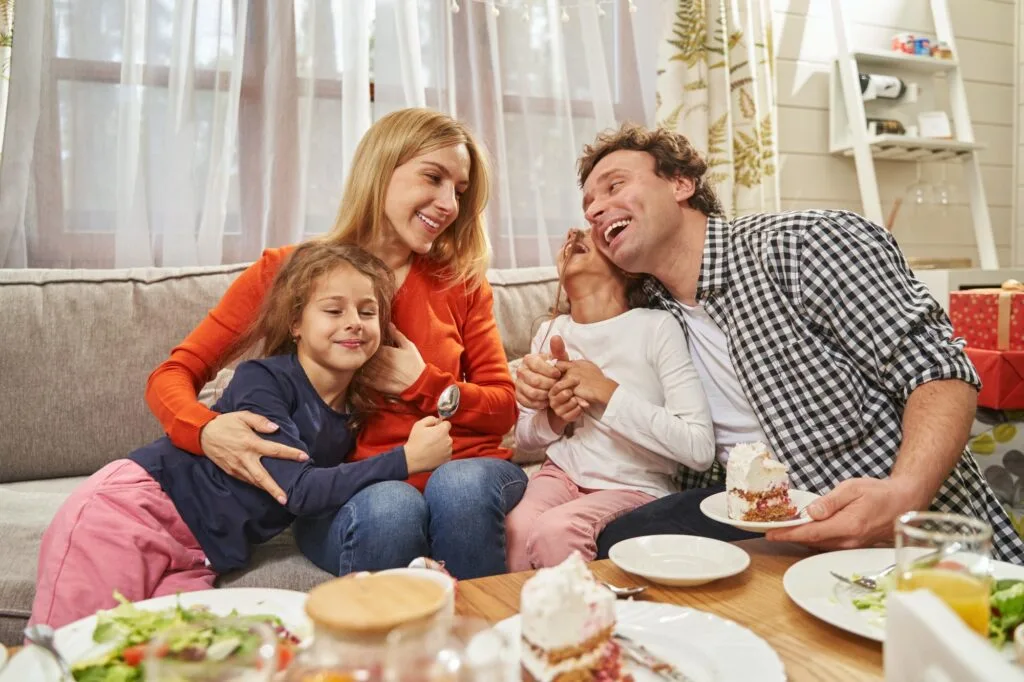 Portrait of loving parents sitting with daughters